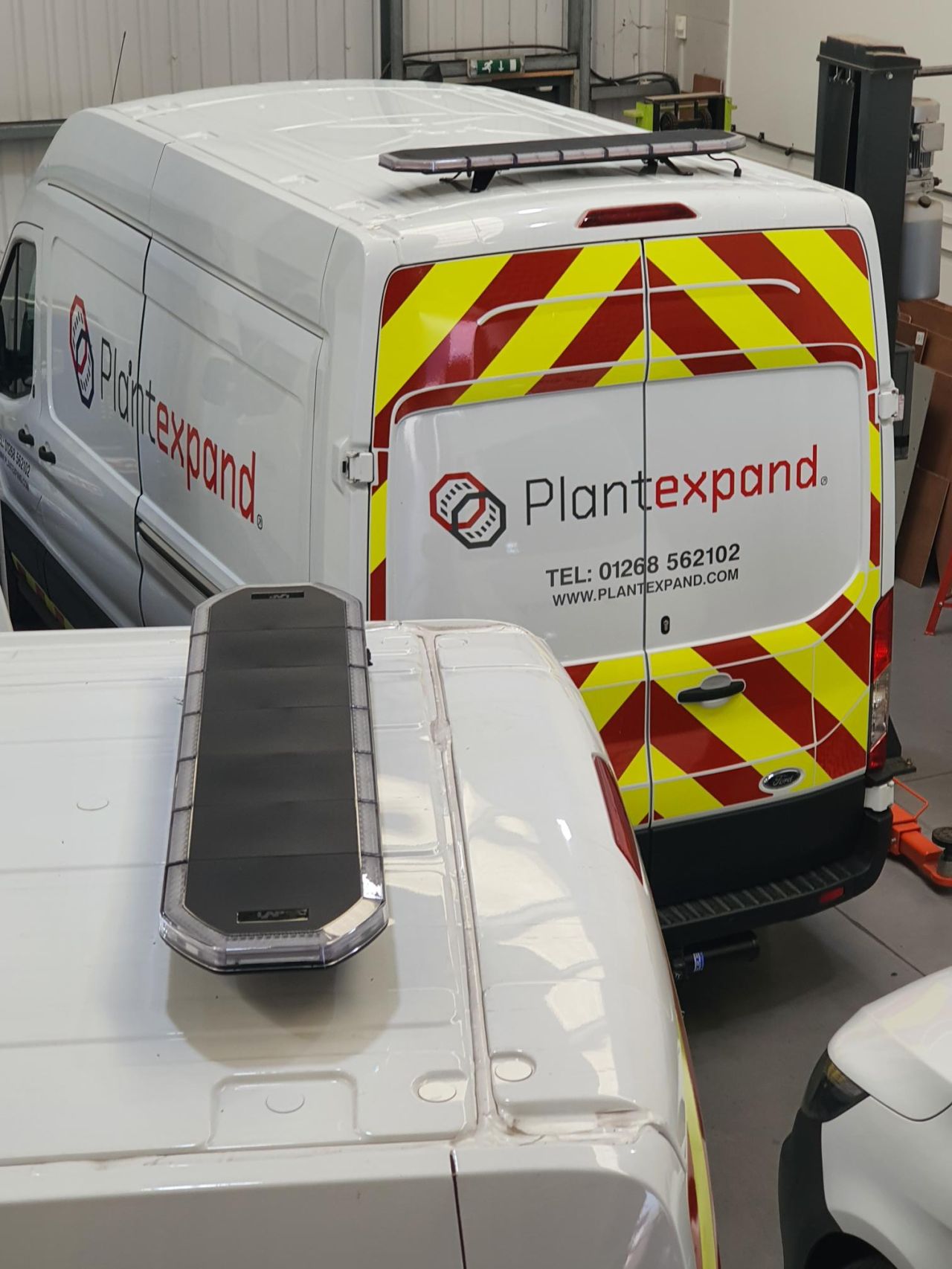 Plant hire van with chevrons and a roof box, fitted at the workshop