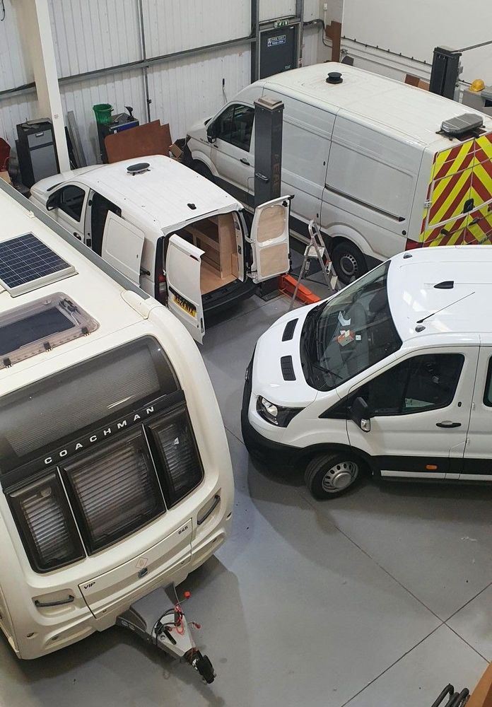 Van with rear doors open during ply lining